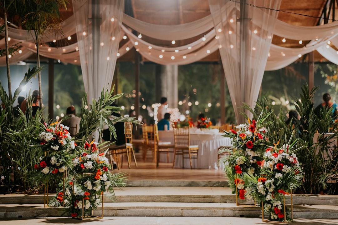 a-room-filled-with-lots-of-tables-covered-in-white-drapes-tyklwdfdrcu