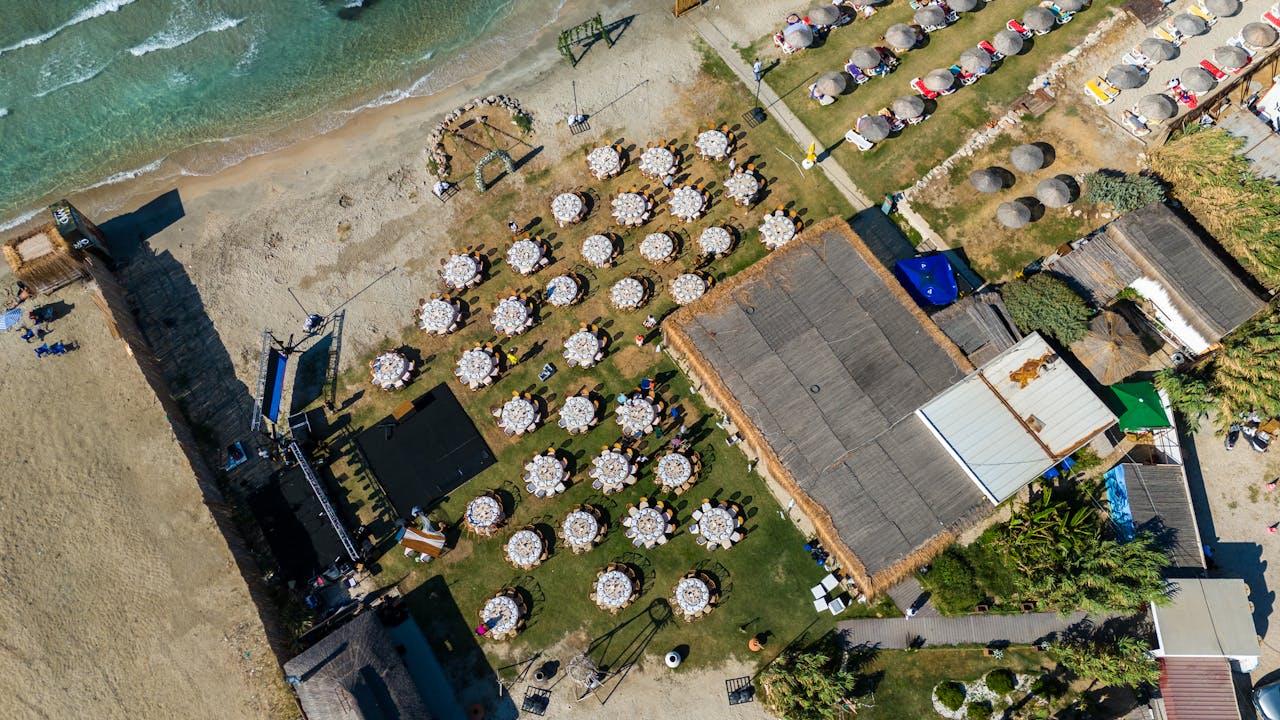 Aerial shot of elegant outdoor beach wedding setup at Çeşme, Türkiye.