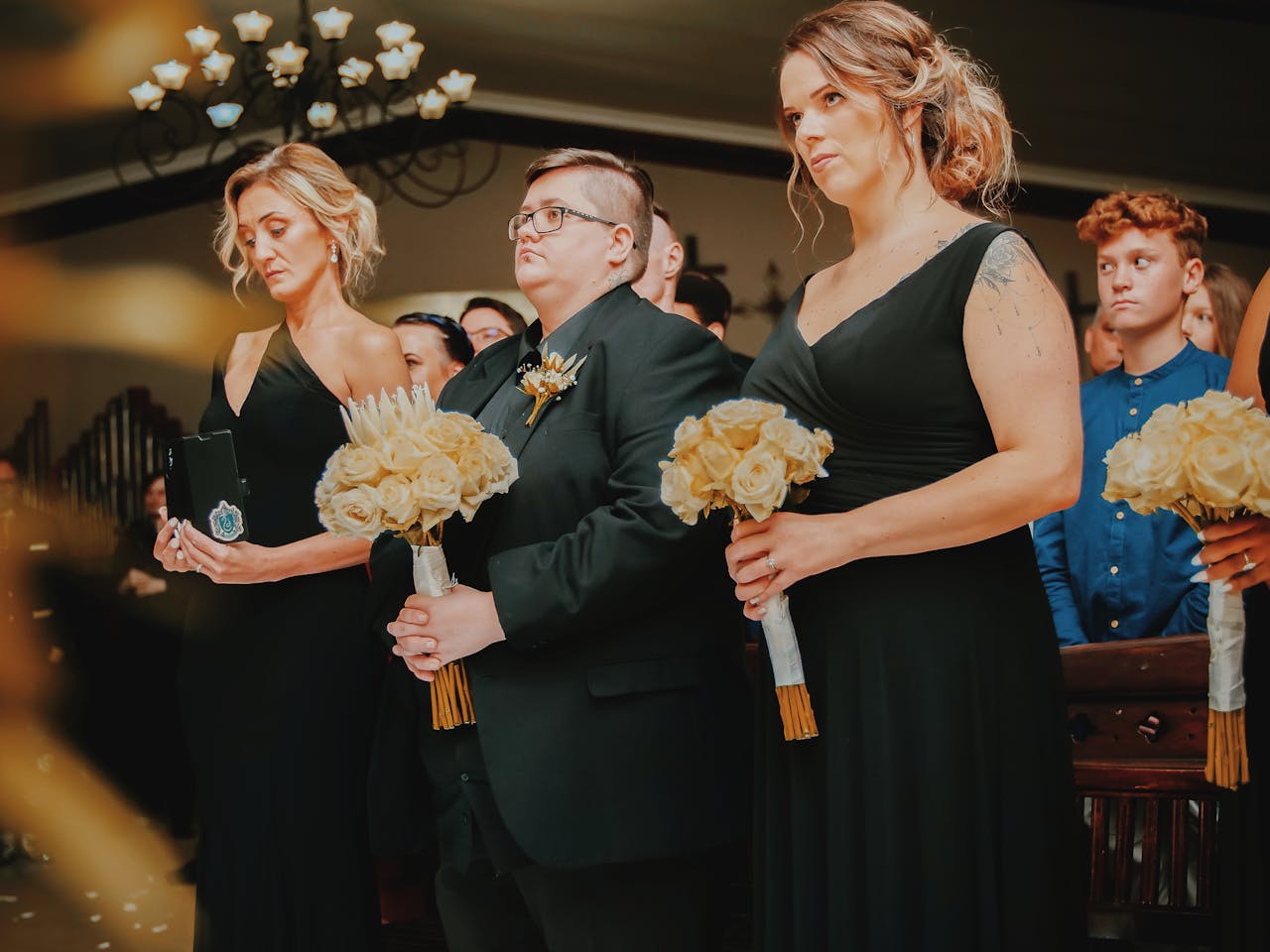 A ceremonial gathering with women holding bouquets, showcasing elegance and solemnity.
